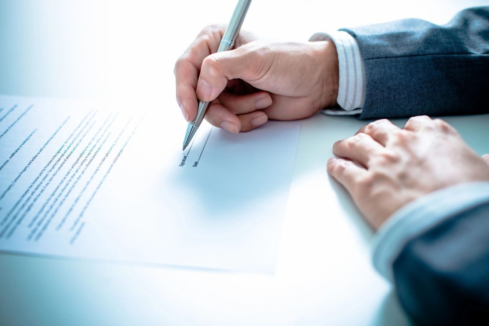 Person signing a legal document.