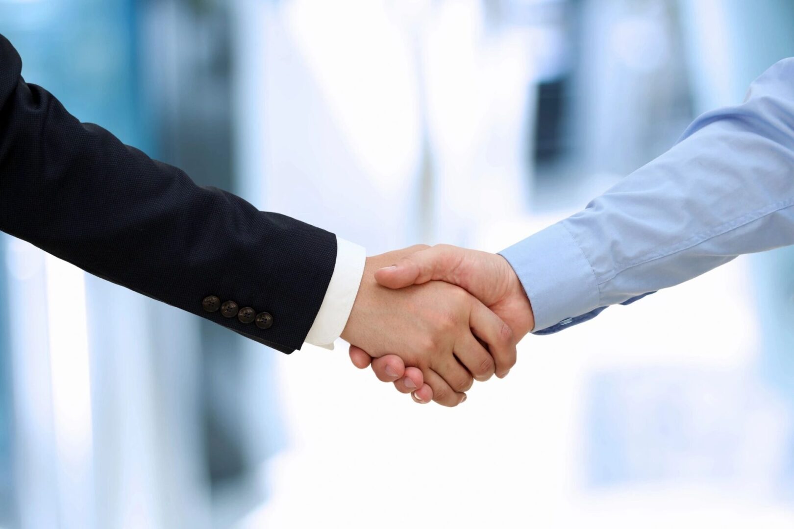 Two businessmen shaking hands in agreement.