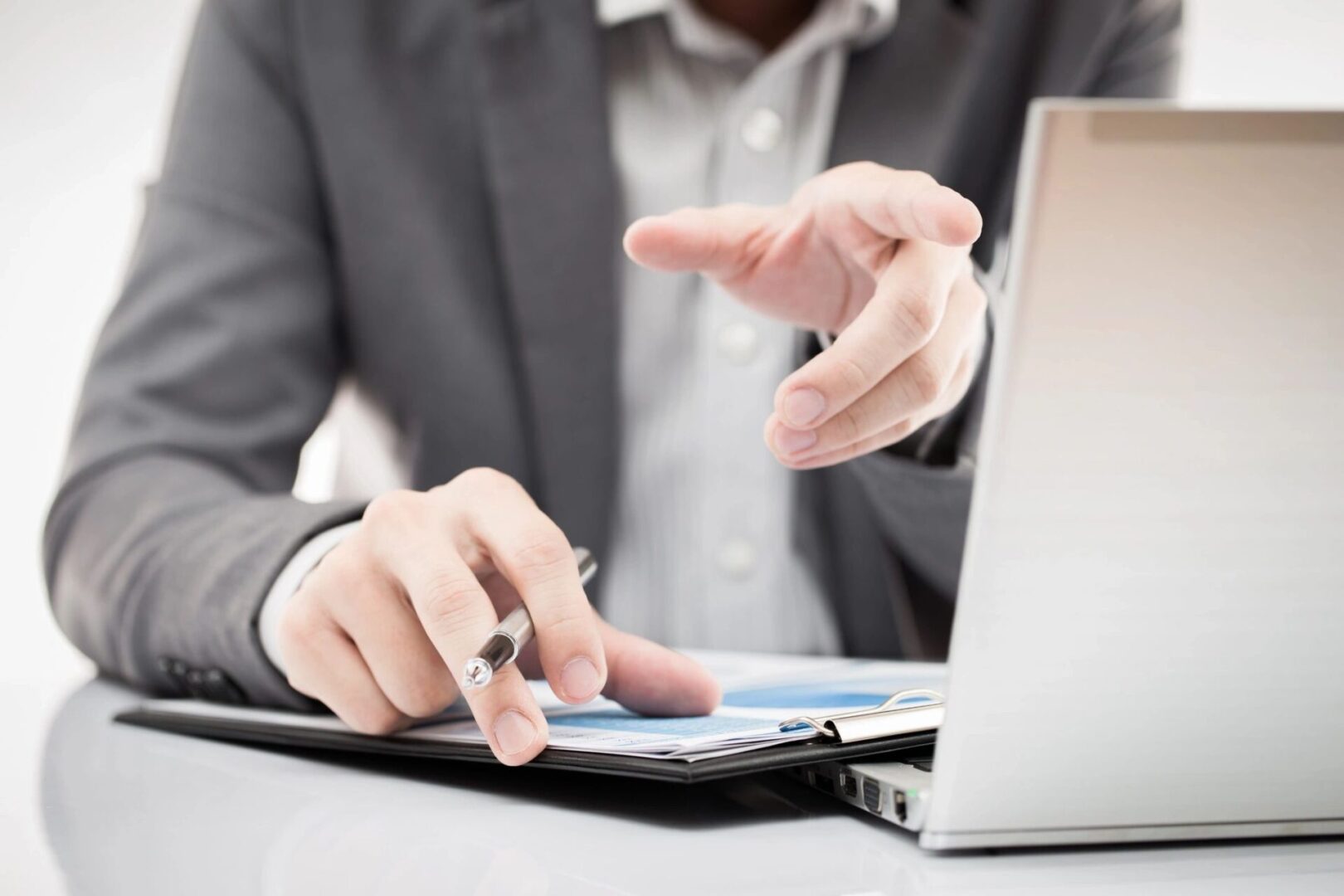 Businessman pointing at laptop screen.